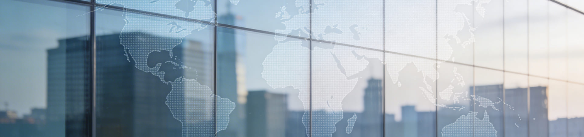 Glass building facade overlaid with a world map
